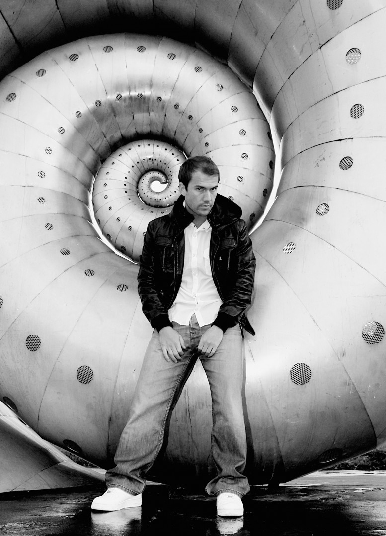 Young male model posing with giant metal snail shell